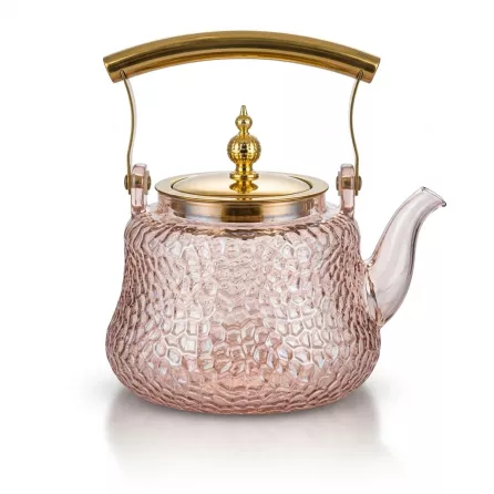 Enhanced Glass teapot with gold handle and lid on countertop