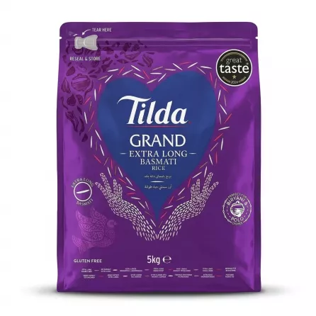A 5kg bag of Tilda Grand Extra Long Basmati Rice is shown centered against a clean white background. The purple bag features the Tilda logo and 'Great Taste 2024' and 'Gluten Free' labels, as well as a window showing the rice. PRODUCT TITLE: Tilda Basmati Rice - Extra Long Grains 5kg PRODUCT: Front of Tilda Grand Extra Long Basmati Rice 5kg bag with great taste award and gluten free label