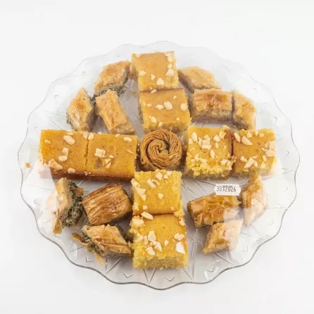 Platter of Hamadah Sultan baklava and semolina sweets with nut topping