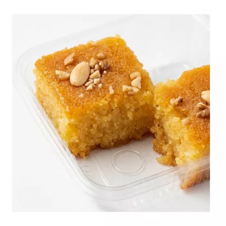 Close-up of Sultan Basbousa semolina cake slice showing moist texture and nut topping