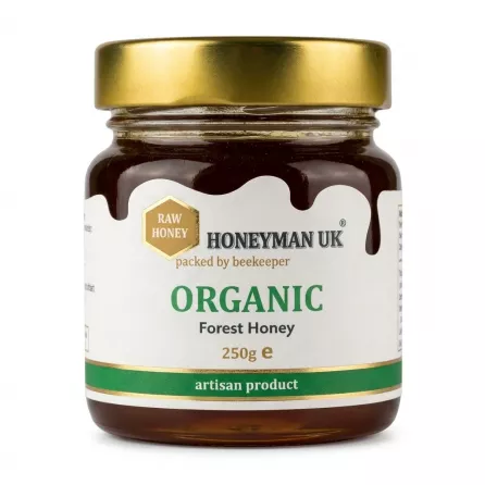 A 250g jar of Honeyman UK Raw Organic Forest Honey, an artisan product featuring a golden lid and clear text label, centered against a solid white background.