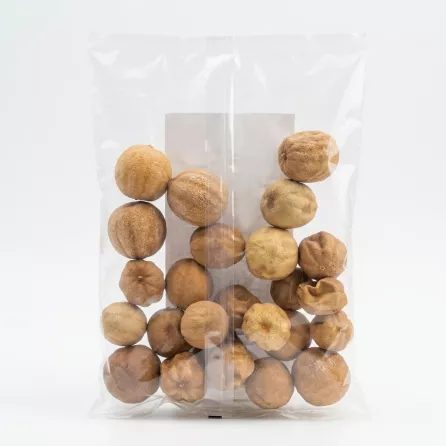 Back view of clear plastic bag containing whole dried white limes