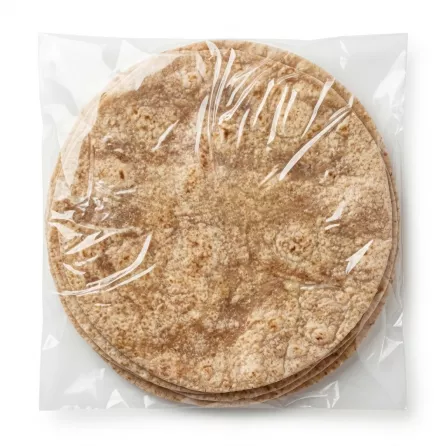 Crispy whole wheat roti flatbreads stacked in clear packaging