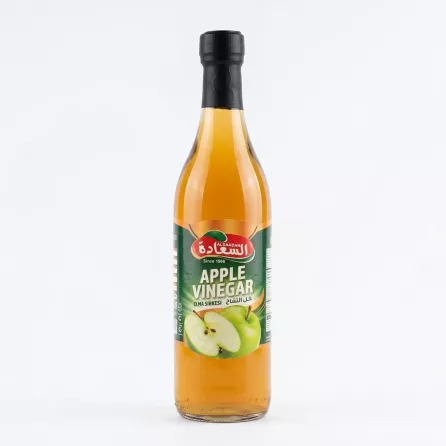 Front view of Alsaadah Apple Vinegar 500ml glass bottle on a store shelf