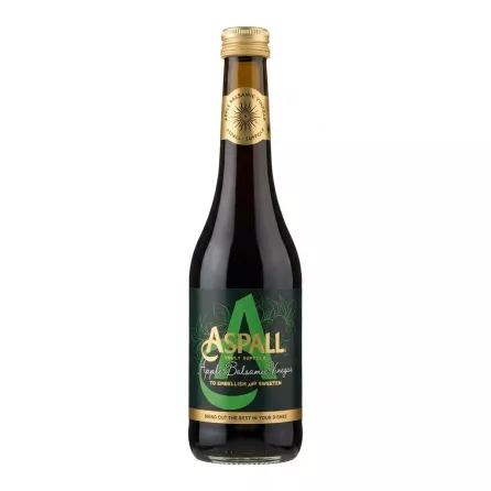 Hand holding a bottle of Aspall Apple Balsamic Vinegar in a shop aisle