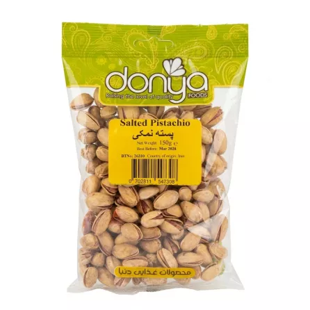 Front view of Donya Salted Pistachio 150g pack in hand on store shelf