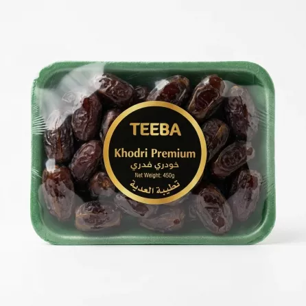 Hand holding Teeba Khodri Premium Dates 450g pack