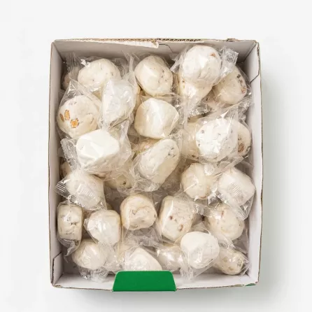 Individually wrapped white nougat candies in a box