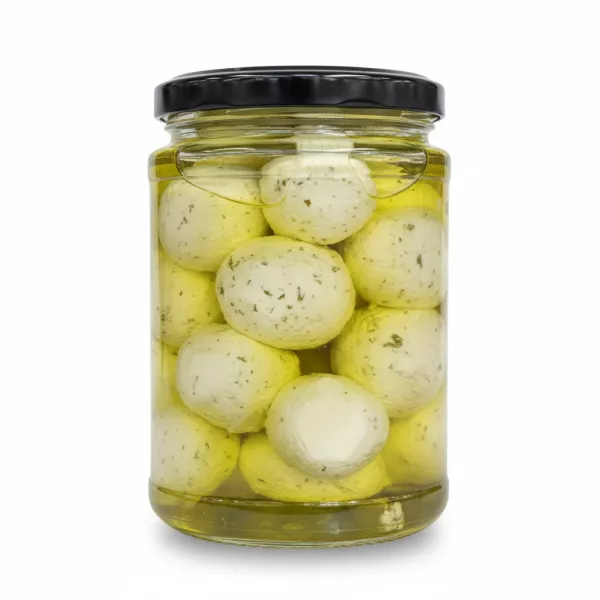 Close-up of Labneh balls immersed in olive oil with mint