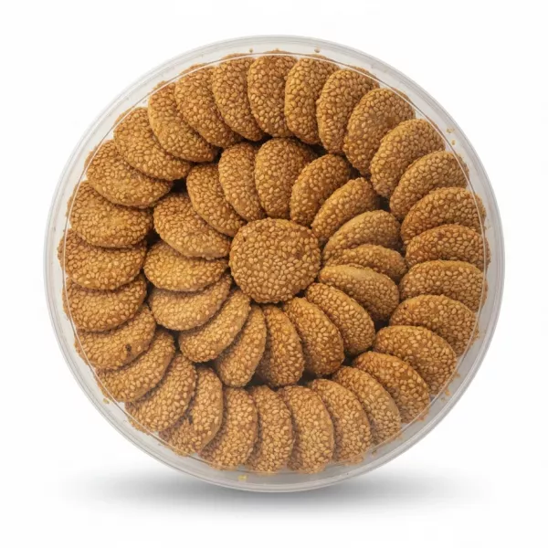 Round transparent tray filled with sesame seed coated Barazek Shamiya cookies