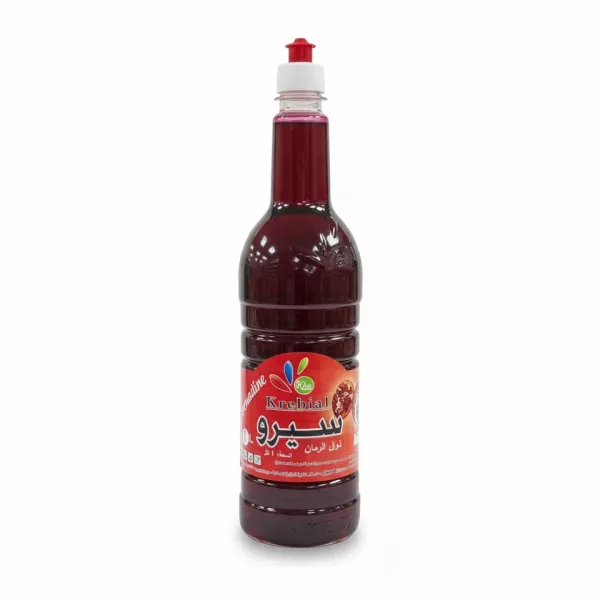 Full bottle of Krebial Algerian pomegranate syrup with red label and easy pour cap