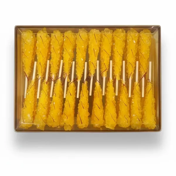 Pack of bright yellow saffron-infused rock candy sticks in transparent box