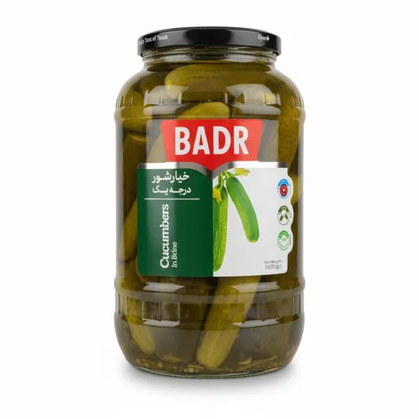 Large glass jar of Badr pickled cucumbers with red and green label