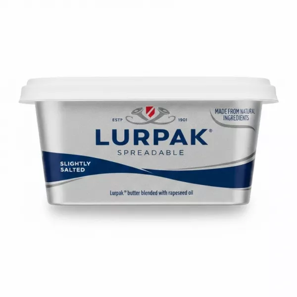 Lurpak Spreadable tub held in hand with label showing brand and product type