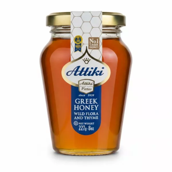 Jar of Attiki Greek Honey Wild Flora & Thyme, clear glass with golden lid
