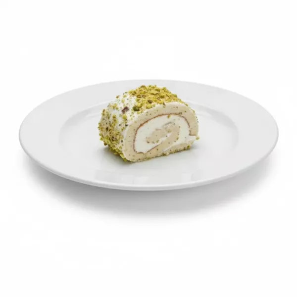 Single slice of pistachio cream roll on white plate, showing creamy filling