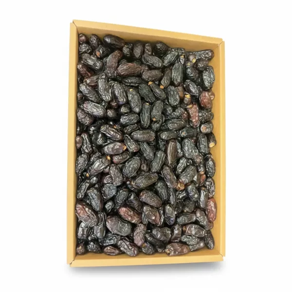 Close-up of dark, wrinkled Ajwa dates packed in a box