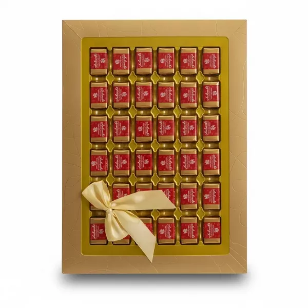 Gold box of individually wrapped Achaachi chocolates with satin bow