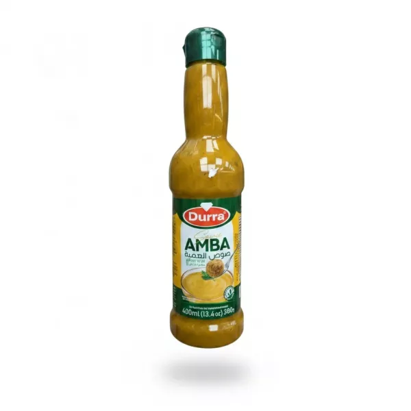 Bottle of Durra Amba sauce with green cap held in hand