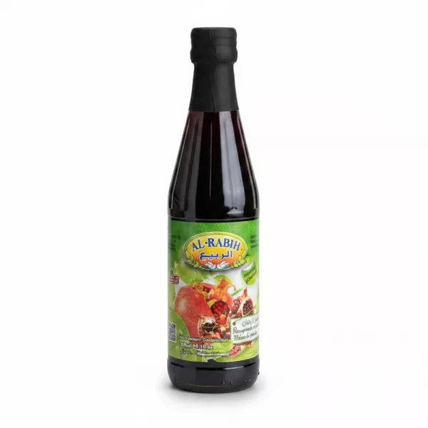 Bottle of Al-Rabih pomegranate molasses held in hand showing front label