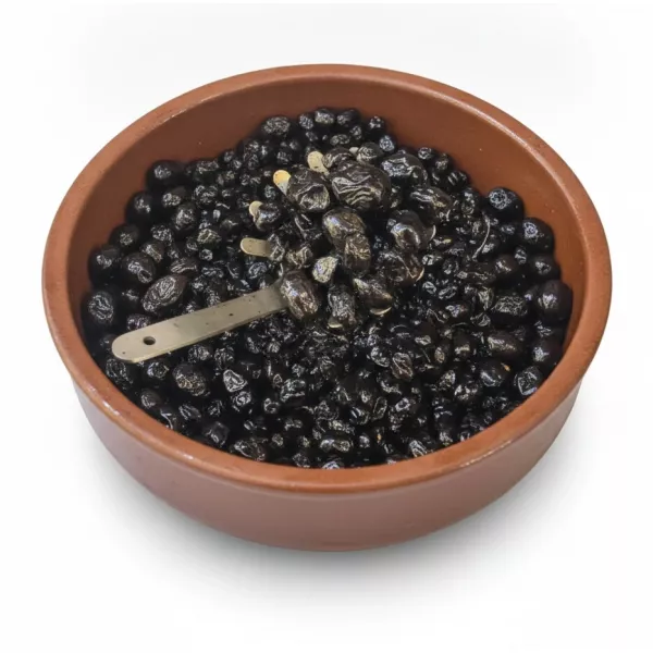 Close-up of shiny black olives in a brown container