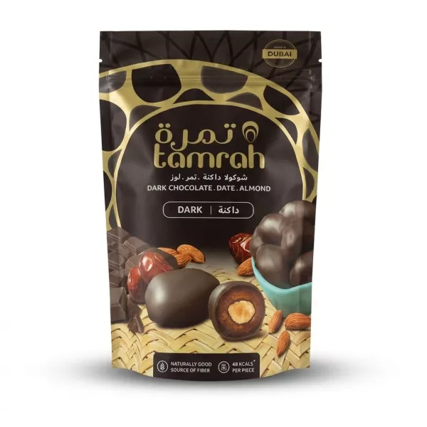 Enhanced Front of Tamrah dark chocolate date almond snack pack, black and gold pouch showing chocolate-coated date with almond centre