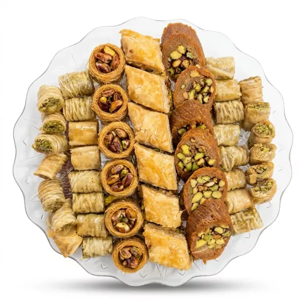 Enhanced Clear plastic tray with assorted Rayan baklawah pastries featuring various nut fillings and golden flaky layers