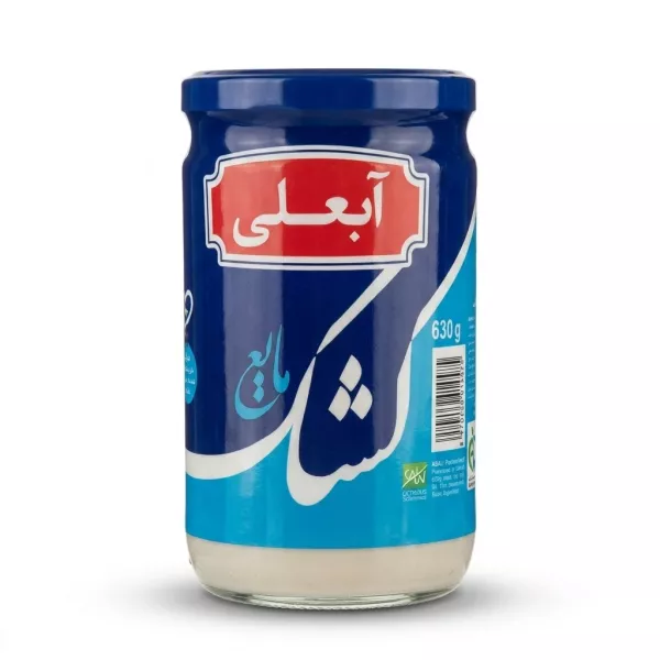 Enhanced Hand holding Abali Pasteurised Kashk jar in grocery store aisle