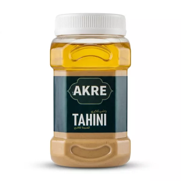 A 1700g plastic jar of AKRE Tahini, an authentic sesame spread, featuring its green and blue label, with a ribbed white cap, displayed on a clean white background with a soft, even shadow.