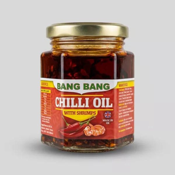 Enhanced Bang Bang Chilli Oil With Shrimps jar held in hand in grocery aisle