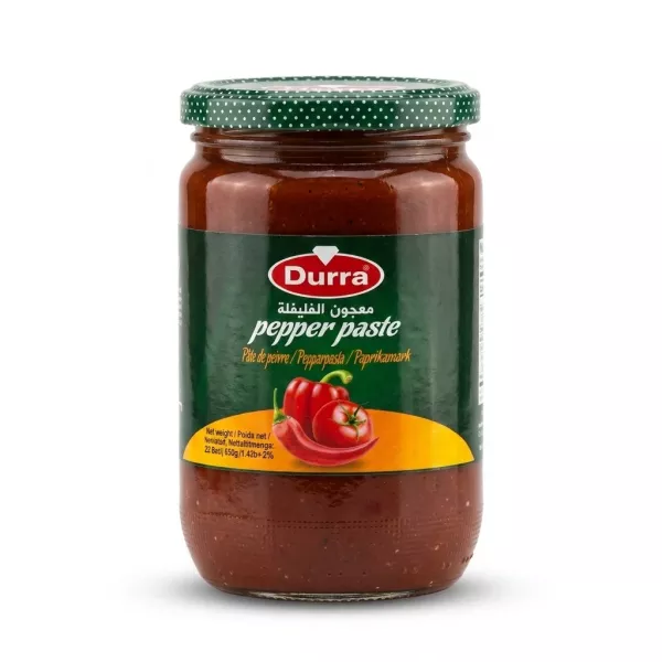Enhanced Front view of Durra Pepper Paste 650g jar held in hand in a grocery aisle