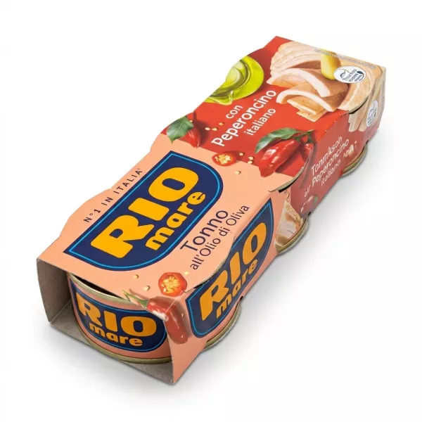 A 1:1 professional e-commerce product photograph of a 3-pack cardboard sleeve containing Rio Mare Tuna in Spicy Olive Oil. The sleeve is peach-colored with red chili images and a blue 'Rio Mare' logo, angled slightly towards the camera against a seamless white background, with a soft, even shadow underneath.