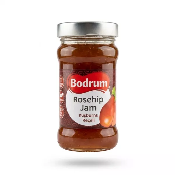 A clear glass jar of Bodrum Rosehip Jam Spread with a silver lid is presented in a professional studio setting against a clean white background.
