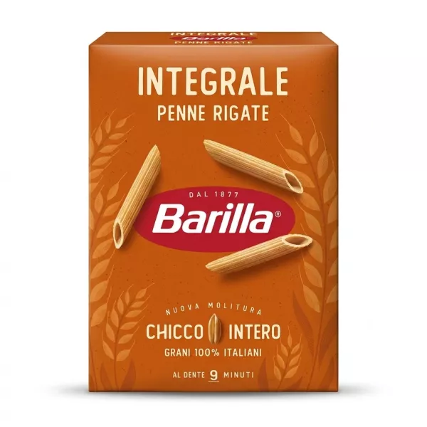 A professional 1:1 e-commerce product photograph of a 500g box of Barilla Wholemeal Penne Rigate pasta on a clean white background. The orange-brown box is centered and takes up 85% of the frame. It displays the text "INTEGRALE PENNE RIGATE" and "Barilla," along with illustrations of wheat and three dry penne pasta pieces. All text and graphics are sharp and clear.