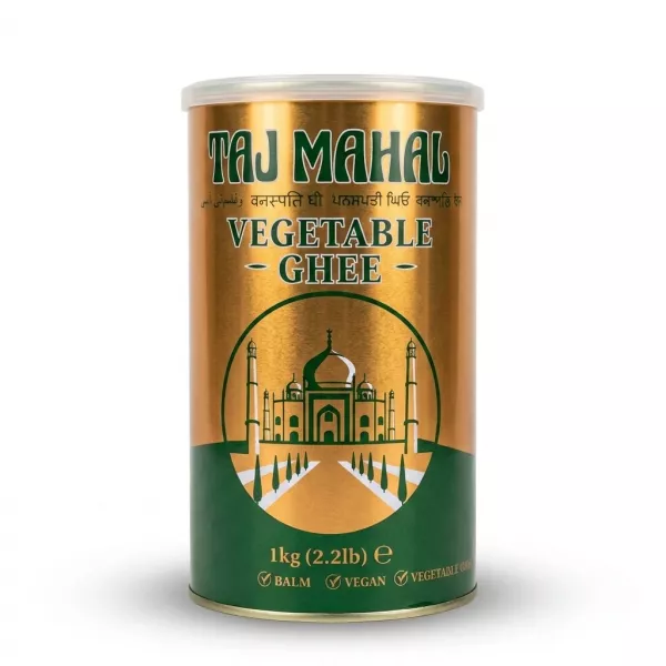 A professional product photo showing the 1kg tin of Taj Mahal Vegetable Ghee. It features a gold and green design with an illustration of the Taj Mahal, centered on a pure white background with soft, symmetrical shadows.