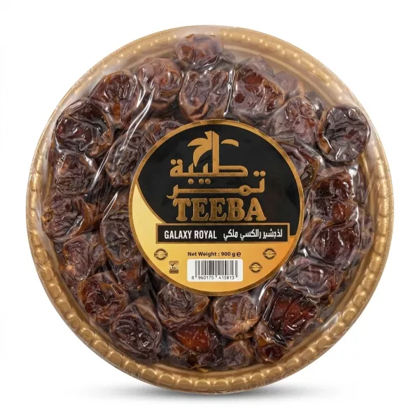 A 900g tray of Teeba Galaxy Royal Saudi Dates, a round plastic platter containing dark brown dried dates with a black and gold central label.