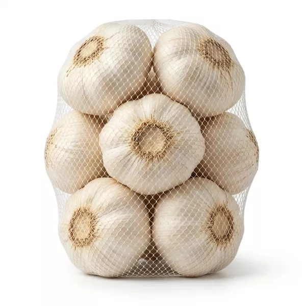 Enhanced Hand holding a mesh bag of whole garlic bulbs with Bravo branding