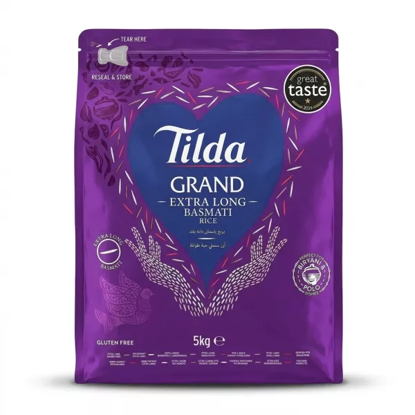 A 5kg bag of Tilda Grand Extra Long Basmati Rice is shown centered against a clean white background. The purple bag features the Tilda logo and 'Great Taste 2024' and 'Gluten Free' labels, as well as a window showing the rice. PRODUCT TITLE: Tilda Basmati Rice - Extra Long Grains 5kg PRODUCT: Front of Tilda Grand Extra Long Basmati Rice 5kg bag with great taste award and gluten free label