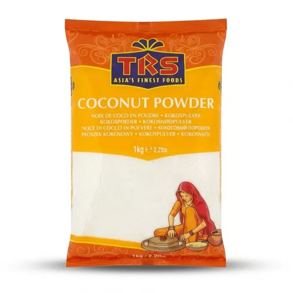 A 1kg plastic bag of TRS brand fine white Coconut Powder. The package has an orange top border with the brand logo and the product name "Coconut Powder" listed in multiple languages. Below, a clear window shows the product, alongside an illustration of a woman in traditional clothing processing coconuts. The bag is centered on a plain white background with professional studio lighting and soft, symmetrical shadows.
