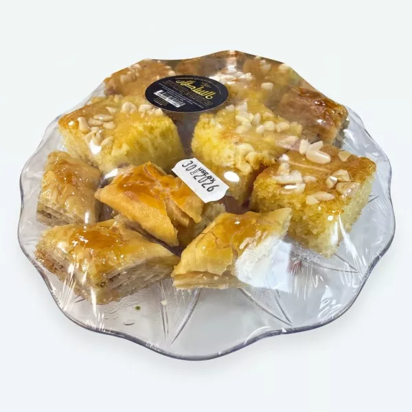 Close-up of Hamadah Sultan sweets tray showing caramelised baklava and nutty semolina cakes with £9.99 label