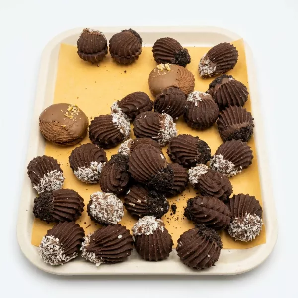 Tray of assorted chocolate cream biscuits with coconut and chocolate crumb toppings