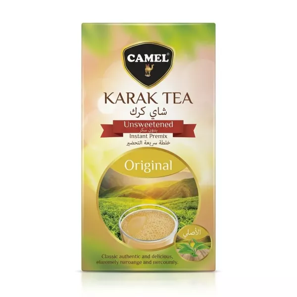 A professional studio photograph featuring a single box of Camel Karak Tea Unsweetened Instant Premix, centered on a solid white background. The box displays the yellow-green packaging with a picture of a steaming cup of tea and a landscape. All text and the camel logo are clearly visible, with no price tags present.