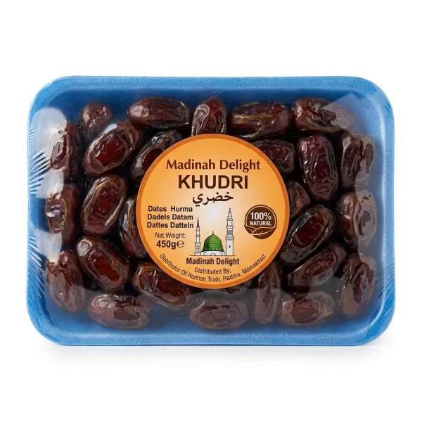 Hand holding a pack of Madinah Delight Khudri Dates 450g with special offer label