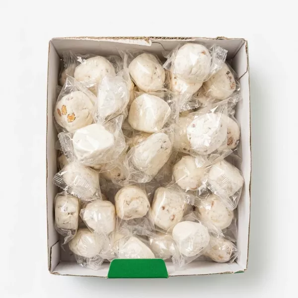 Individually wrapped white nougat candies in a box