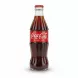 Hand holding a Coca Cola original taste 250ml glass bottle with red label