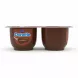 Hand holding two Danette chocolate dessert cups side view showing product branding