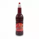 Full bottle of Krebial Algerian pomegranate syrup with red label and easy pour cap