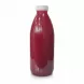 Fresh Pom pomegranate juice bottle showing vibrant red juice inside on a white background