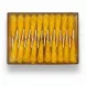 Pack of bright yellow saffron-infused rock candy sticks in transparent box