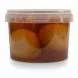 Side view of pickled lemons inside transparent container with brine